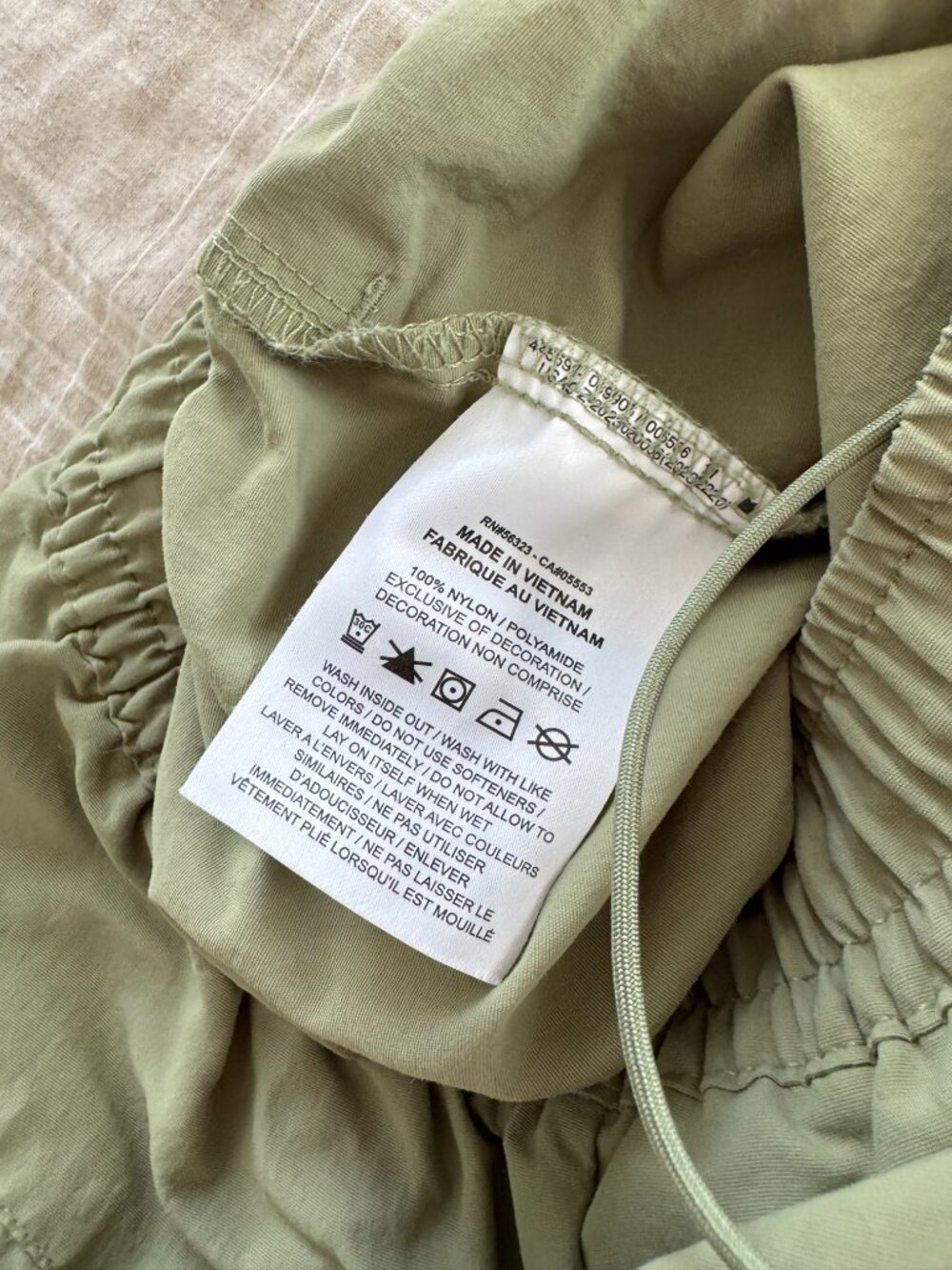 Nike Everythings Woven Mid Rise Open Hem Pant in Olive - Picture 9 of 14